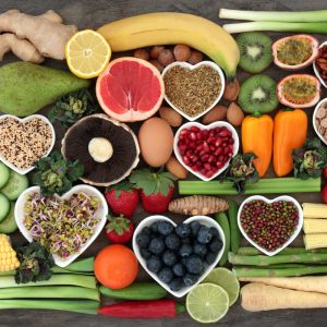 Super food concept for a healthy diet with fruit and vegetables, dairy, spices, nuts, legumes, cereals and grains, high in antioxidants, anthocyanins, dietary fibre and vitamins.